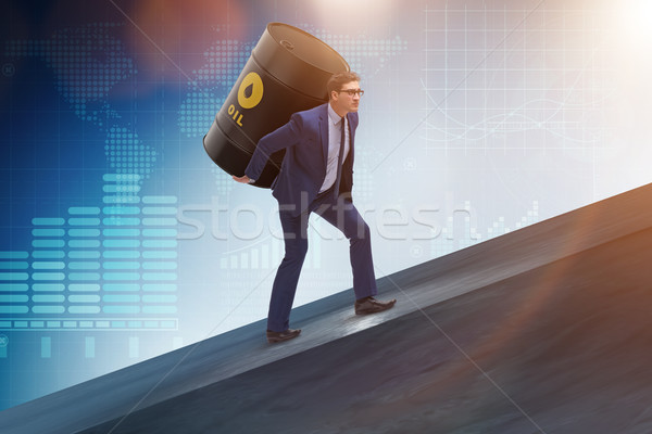 Businessman under the burden of oil barrel Stock photo © Elnur