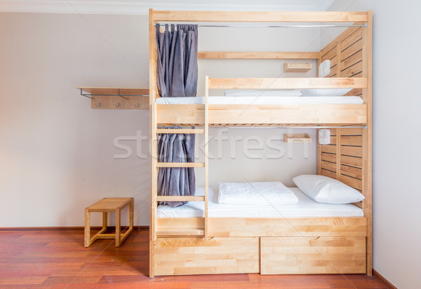 Hostel dormitory beds arranged in room Stock photo © Elnur