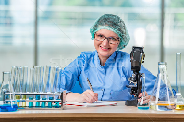 Experienced lab assistant working on chemical solutions Stock photo © Elnur