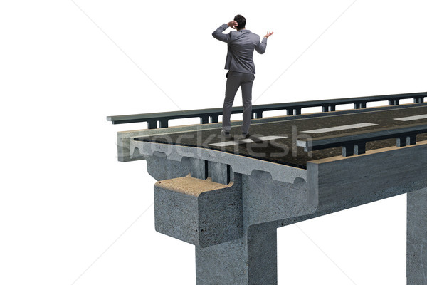 Young businessman with broken bridge isolated on white Stock photo © Elnur