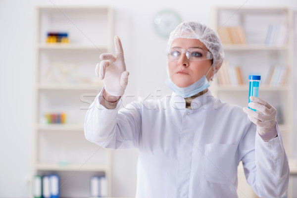 The woman chemist pressing virtual button in lab Stock photo © Elnur