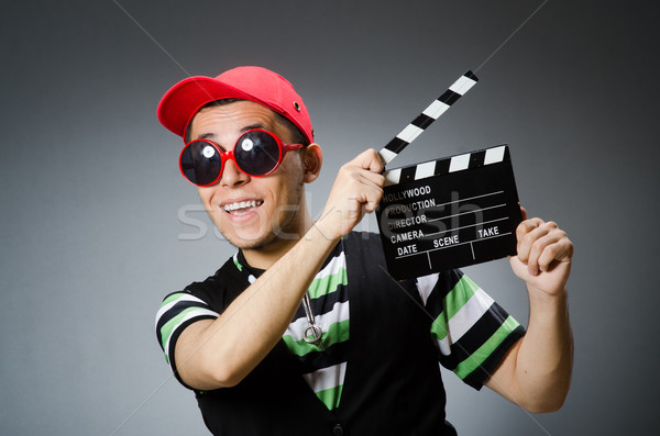 Man with baseball cap and movie board Stock photo © Elnur