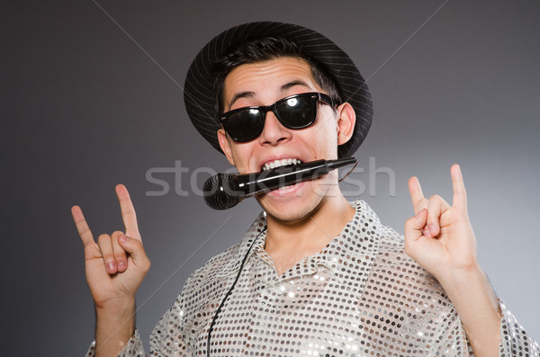 Young Man In Silver Shirt And Microphone Isolated On White Stock