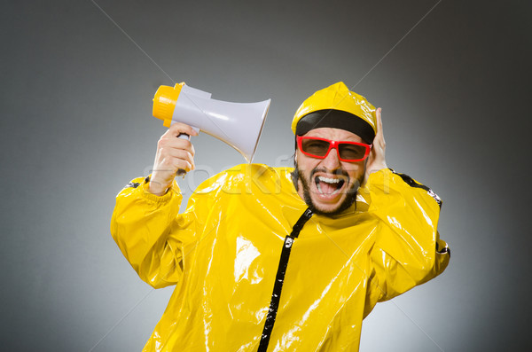 Man wearing yellow suit with loudspeaker Stock photo © Elnur