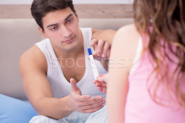Stock photo: Young family with pregnancy test results