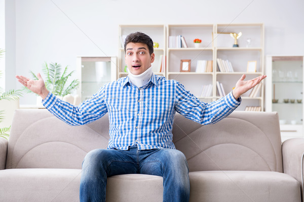 Young man suffering a neck spine head trauma wearing a cervical  Stock photo © Elnur