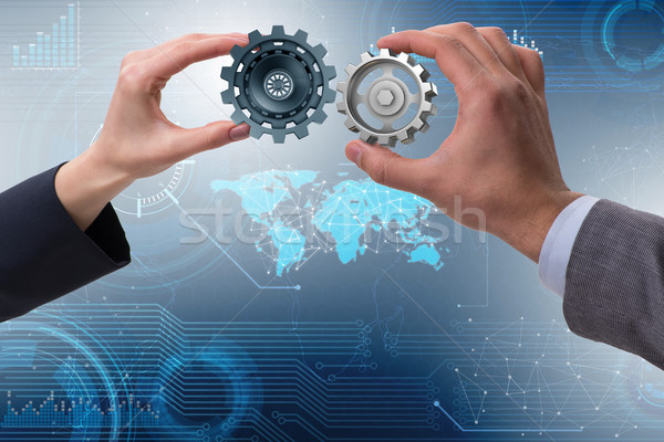 Businessman in teamwork concept with cogwheels Stock photo © Elnur