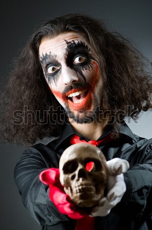 Joker personification with man in dark room Stock photo © Elnur