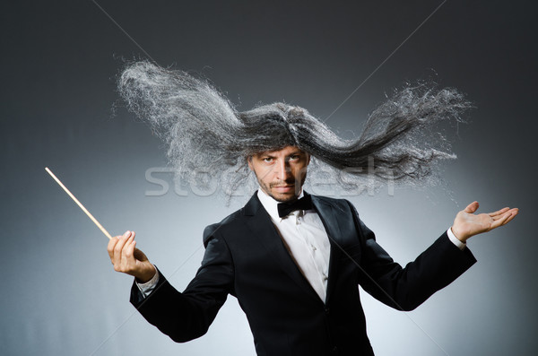 Stock photo: Funny conductor with long grey hair