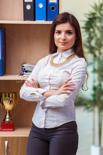 Young businesswoman standing next to shelf Stock photo © Elnur