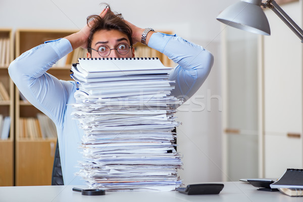 Stock photo: Mad businessman with piles of papers