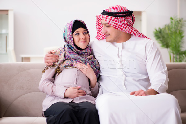Stock photo: Young arab muslim family with pregnant wife expecting baby