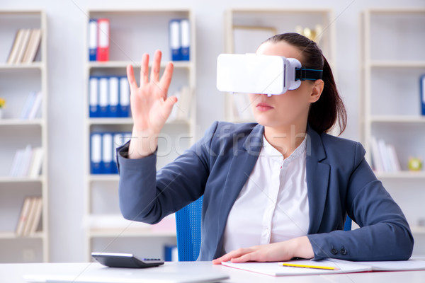 Businesswoman with virtual reality glasses in office Stock photo © Elnur