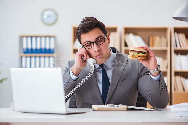Hungry funny businessman eating junk food sandwich Stock photo © Elnur