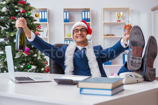 Businessman celebrating christmas holiday in the office Stock photo © Elnur