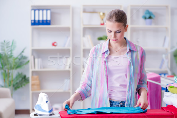 Happy housewife doing ironing at home Stock photo © Elnur
