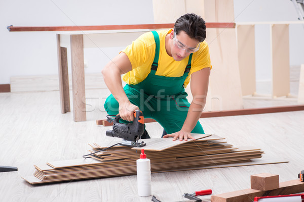 Stock photo: Contractor working on laminate wooden floor 