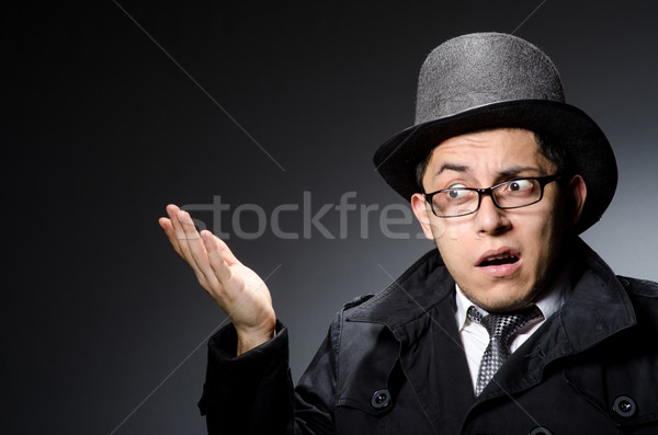Young man in black coat and hat against gray Stock photo © Elnur