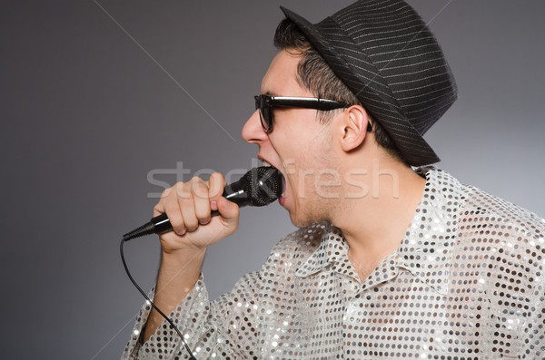 Young man in silver shirt and microphone isolated on white Stock photo © Elnur