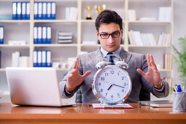 Young businessman in time management concept Stock photo © Elnur