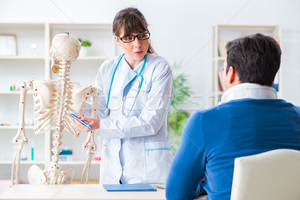Doctor is explaining to patient with neck injury Stock photo © Elnur