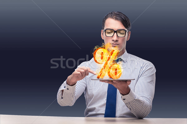 Businessman with percent sign in high interest concept Stock photo © Elnur