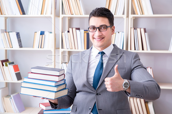 Business law student with pile of books working in library Stock photo © Elnur