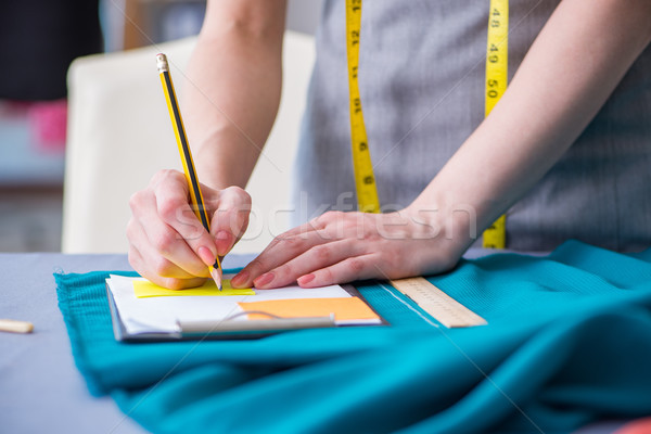 Woman tailor working on a clothing sewing stitching measuring fa Stock photo © Elnur