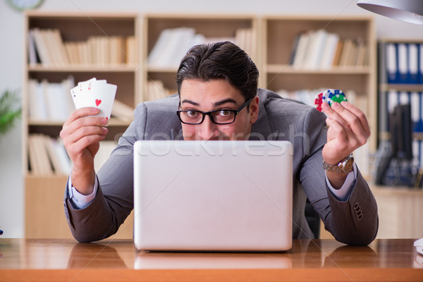 Stock photo: Businessman gambling playing cards at work