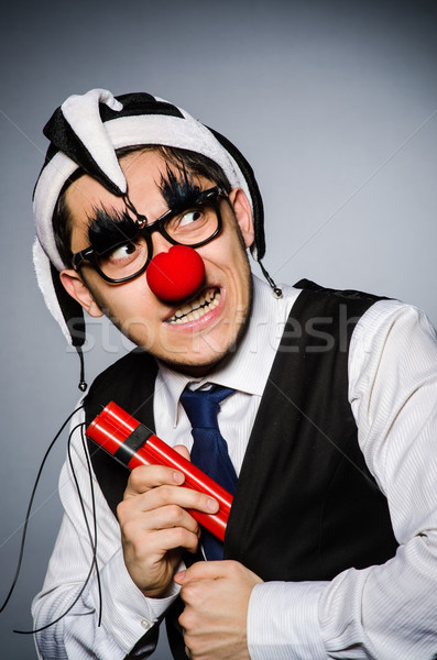 Stock photo: Funny clown with sticks of dynamite