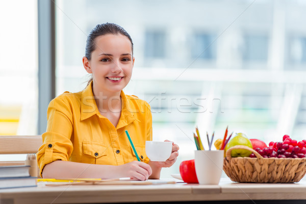 Young school gilr drawing pictures at home Stock photo © Elnur