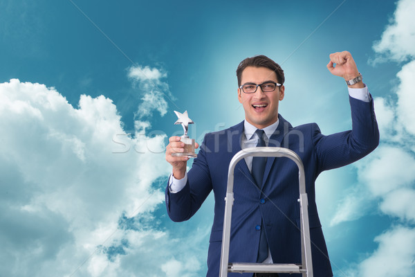 Stock photo: Businessman with star award against sky