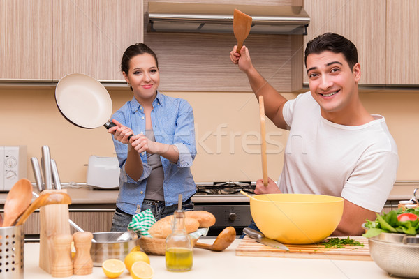 The young family doing funny fight at kitchen Stock photo © Elnur