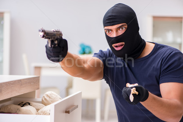 Robber wearing balaclava stealing valuable things Stock photo © Elnur