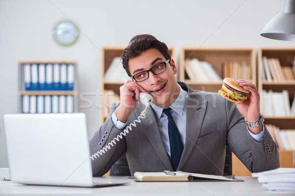 Stock photo: Hungry funny businessman eating junk food sandwich