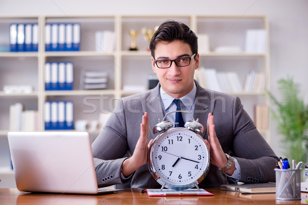 Young businessman in time management concept Stock photo © Elnur