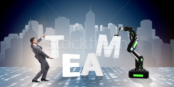 The man and robotic arm in teamwork concept Stock photo © Elnur