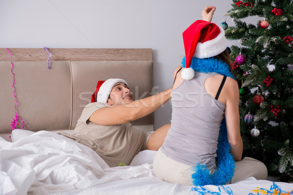 Young happy family celebrating christmas in bed Stock photo © Elnur