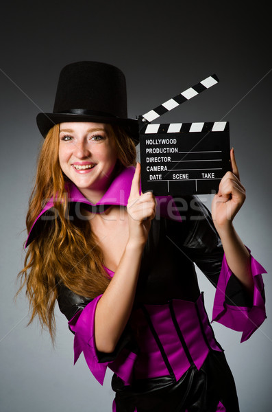 Woman with movie clapboard against grey background Stock photo © Elnur