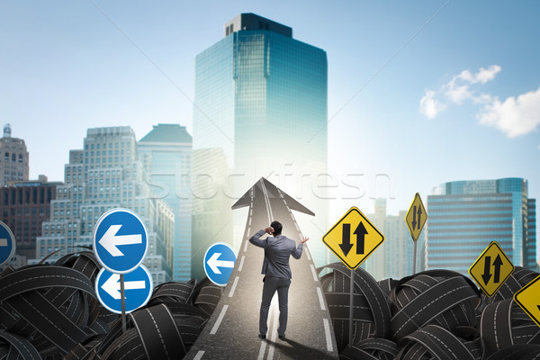 Businessman in uncertainty concept on road intersection crossroa Stock photo © Elnur