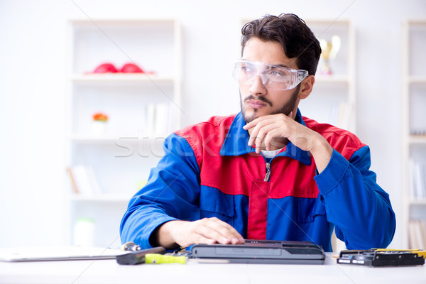 Repairman working in technical support fixing computer laptop tr Stock photo © Elnur