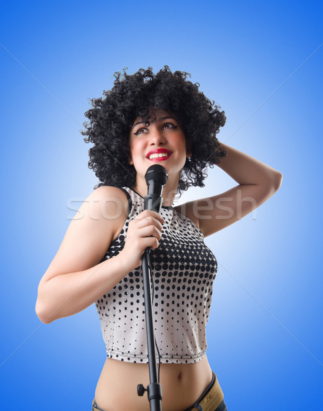 Pop star with mic  on white Stock photo © Elnur