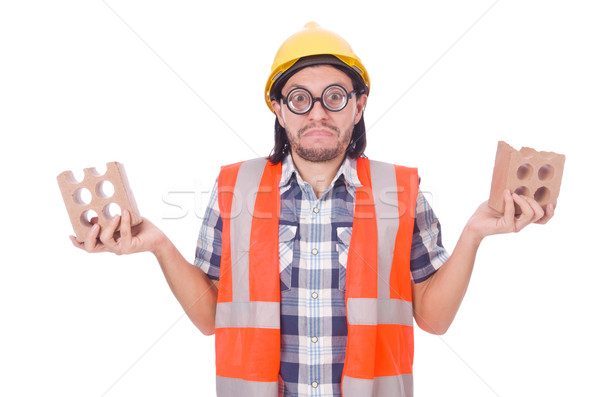 Stock photo: Funny young construction worker with broken brick isolated on white