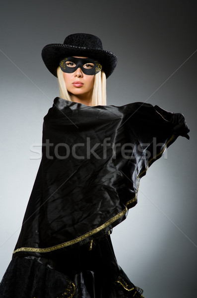 Woman wearing mask against dark background Stock photo © Elnur