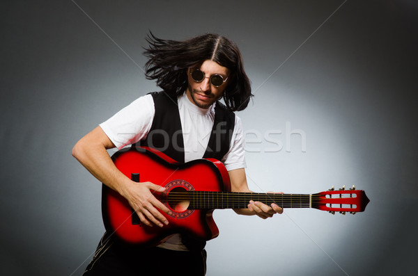Man wearing sunglasses and playing guitar Stock photo © Elnur