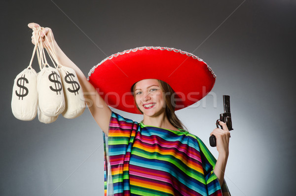 Girl in mexican poncho holding handgun and money sacks against g Stock photo © Elnur