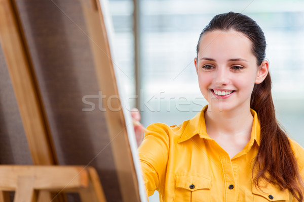 Young student artist drawing pictures in studio Stock photo © Elnur