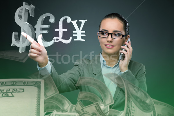 Businesswoman with currencies in business concept Stock photo © Elnur