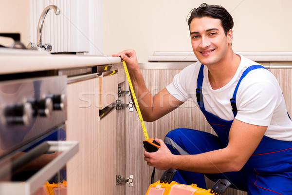 Young repairman working at the kitchen Stock photo © Elnur