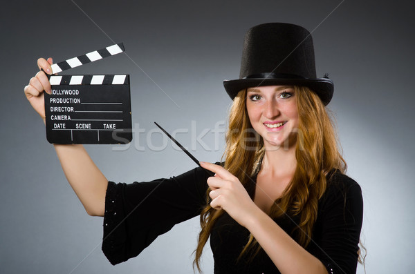 Woman with movie clapboard against grey background Stock photo © Elnur